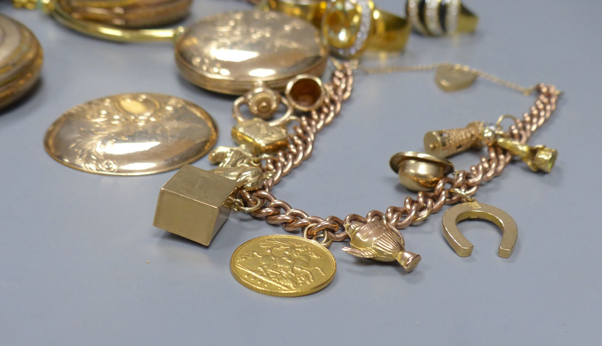 A modern 9ct gold curblink charm bracelet, hung with eleven assorted charms, including 9ct, gross 35 grams & other jewellery.